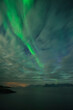 © Cavan Images - Northern Lights - Aurora Borealis emerge from behind clouds, near HenningsvÃ¦r, AustvÃ¥gÃ¸y, Lofoten Islands, Norway