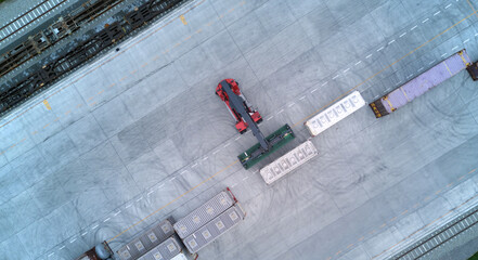 Wall Mural - Aerial top down view crane loading container from container truck to container train, Cargo train with freight train container, Business import export logistic and transportation railway.