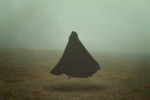 Black Cloak In A Desolate Field