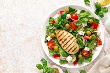 Canvas Print - Grilled chicken fillet and fresh green leafy vegetable salad with tomatoes, red onion, olives and feta cheese. Healthy food. Ketogenic lunch. Top view