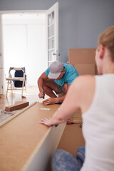 Wall Mural - Husband and wife assembling new furniture - home renovation concept.