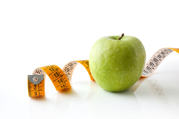 Wall Mural - Healthy background with apple and tape measure and isolated background