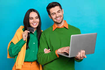 Poster - Photo of married couple use netbook credit card choose online buying valentine day party isolated blue color background
