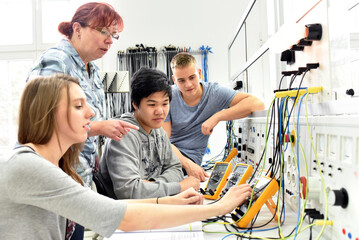 Group of young people in technical vocational training with teacher