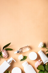 Poster - Natural cosmetic products. Cream, serum, tonic with green leaves and flowers. Skin care concept. Vertical image.