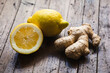 Fresh ginger root and lemon on rustic, wooden table