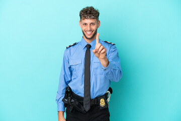 Canvas Print - Young police blonde man isolated white on blue background showing and lifting a finger