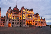Hungarian Parliament Building In The Evening At The Danube River In Budapest, Hungary