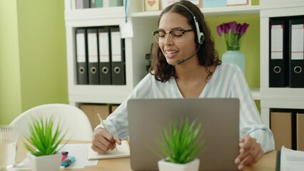 Wall Mural - Young african american woman business worker having video call at office