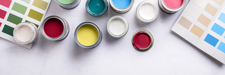 Wall Mural - Tiny sample paint cans during house renovation, process of choosing paint for the walls, different colors, color charts on background, banner size