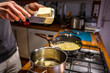 © carolvis - A boy putting butter in a cooking pot.