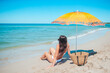 © travnikovstudio - Young beautiful woman relaxing at white sand tropical beach