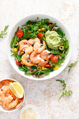 Sticker - Shrimp and leafy vegetables salad with tomato, bell pepper, olive and avocado sauce. Top view