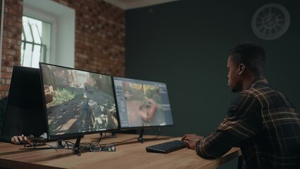 computer game developer creating new interface for game, african american man working in office