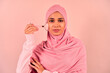 © Velista production - A modern, young, beautiful Muslim woman uses a massage quartz roller for her face. Skin care.