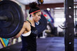 © Cavan Images - A female athlete trains in a crossfit gym.