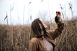 © Cavan Images - Portrait of a beautiful young woman in warm clothes outdoors