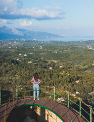 Wall Mural - View of Kaiser's Throne observation deck lookout, Pelekas village, Corfu island, Greece, Kaiser William II summit Observatory panoramic summer view with mountains and Kerkyra in the background