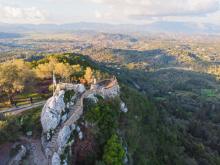 View of Kaiser's Throne observation deck lookout, Pelekas village, Corfu island, Greece, Kaiser William II summit Observatory panoramic summer view with mountains and Kerkyra in the background