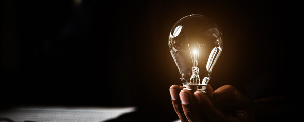 close up hand choose light bulb or lamp with bright light for human resources or leadership and crea