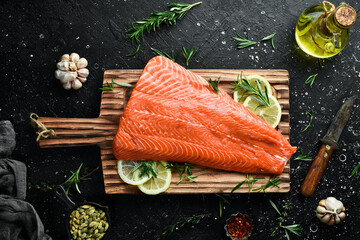 Wall Mural - Raw salmon fillet on a wooden board. Recipe. Top view. Seafood.