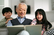 © imtmphoto - asian grandpa and two grandchildren having a good time at home