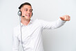 © luismolinero - Telemarketer Brazilian man working with a headset isolated on white background giving a thumbs up gesture