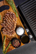 © Richard Semik - ribeye steak on wooden board with spices and electric grill