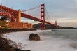 Golden gate bridge in misterious light on white waves photographed from the bay