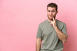 © luismolinero - Young caucasian man isolated on pink background and thinking