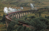 Fototapeta Most - Views of the Glenfinnan Viaduct with the passing steam train
