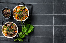 Beef Bourguignon Meat Stew With Vegetables, Mushrooms And Red Wine In A Pot. Black Background. Top View. Copy Space