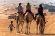 © Allison - people riding camels in the desert