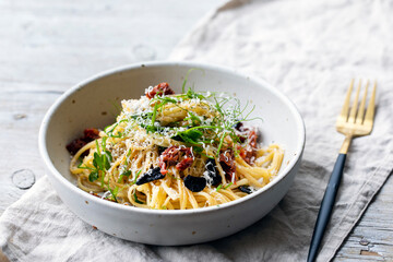 Wall Mural - Linguine pasta with black garlic, sundried tomatoes and pea shoots