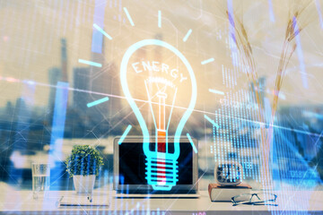 Poster - Computer on desktop in office with bulb icon hologram. Double exposure. Concept of idea.