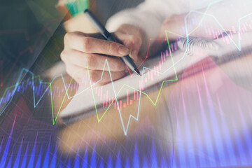 Poster - Financial forex graph displayed on hands taking notes background. Concept of research. Double exposure