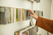 Close-up Of A Woman Hand Picking A Cd From Shelf, Munich, Bavaria, Germany