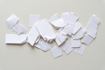 Wall Mural - torn and cut white paper pieces piled on blank paper with texture