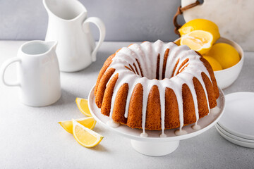 Wall Mural - Lemon bundt cake drizzled with powdered sugar glaze