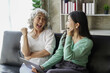 © Tj - Candid attractive beautiful mum sit at cozy sofa couch living room in family moment grown child kid celebrate joy good warm time kiss relationship with retired overjoy lady girl health life.