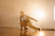 © Wavebreak Media - Image of biracial male modern dancer dancing in smoked interior