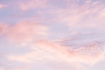 Wall Mural - blue sky background with white and pink clouds at sunset
