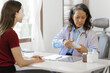 © NanSan - Elderly Asian female nurse teaches caucasian patient about advice and correct information. for the use of paracetamol to treat pain