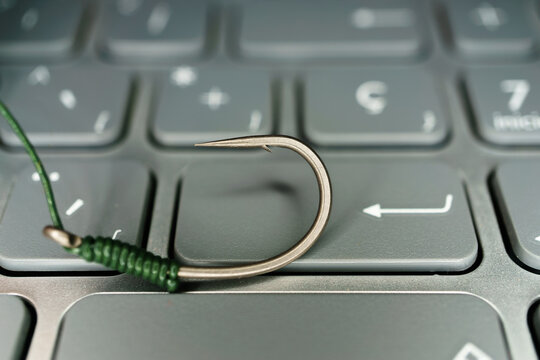 hook on the keyboard of a computer phising concept