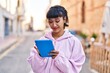 © Krakenimages.com - Young woman smiling confident using touchpad at street
