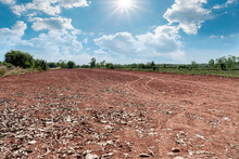 Empty Dry Cracked Swamp Reclamation Soil, Land Plot For Housing Construction Project With Car Tire Print In Rural Area And Beautiful Blue Sky With Fresh Air Land For Sales Landscape Concept
