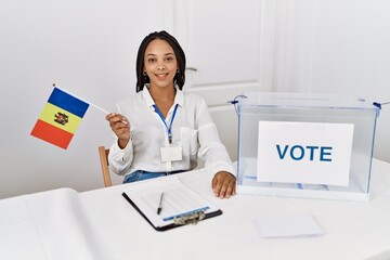 Canvas Print - Young african american woman smiling confident holding moldova flag working at electoral college