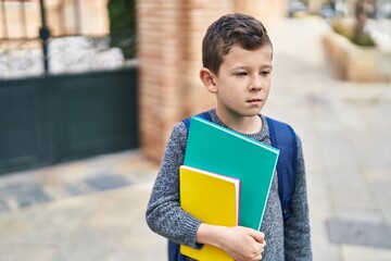 Poster - Blond child student holding books standing at street