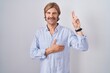 © Krakenimages.com - Caucasian man with mustache standing over white background smiling swearing with hand on chest and fingers up, making a loyalty promise oath