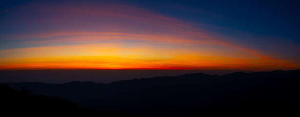 Wall Mural - panorama aerial view sunset , sunrise over dark mountain with fog over the ground.the early evening 